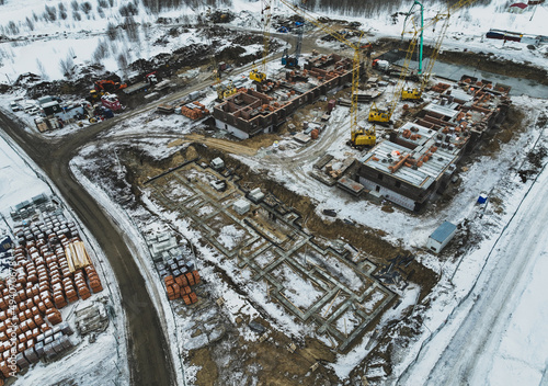 The foundation of a residential building. View from above. Construction background. Snowy winter