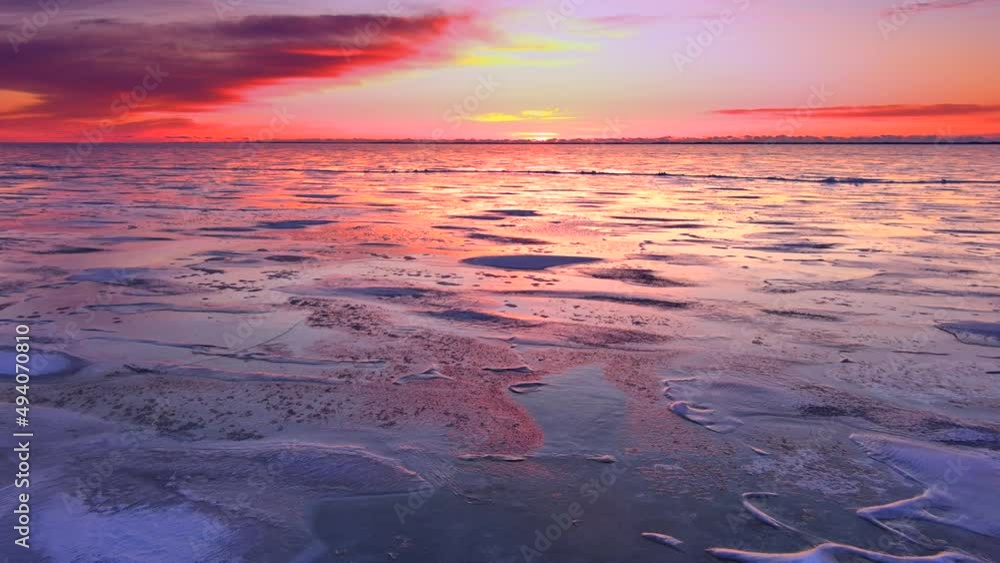 Dawn low aerial view of the vast ice plain across the frozen Bay of Green Bay
