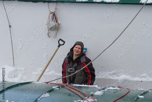 A climber cleans the roof from snow	