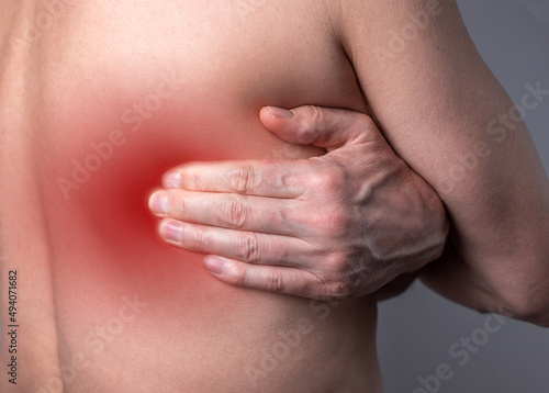 Back pain, self-massage ofaching trigger points, spots on backside, close up. High quality photo