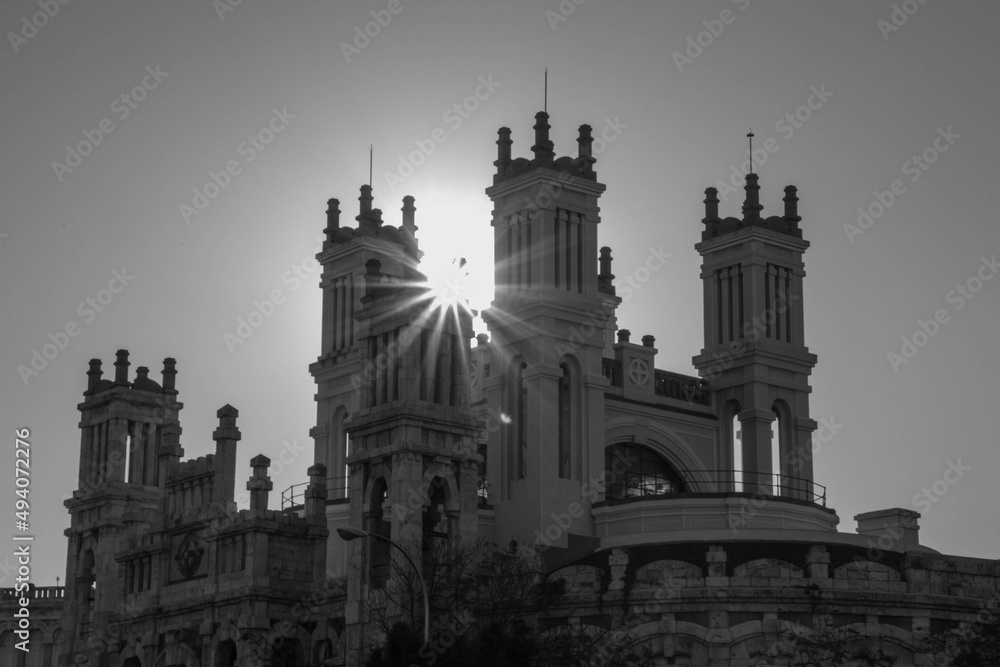 Black and white church with sun between two towers