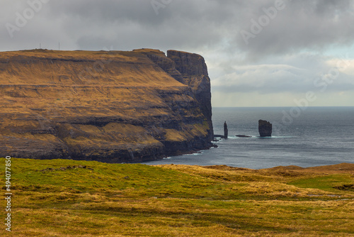 Risin og Kellingin rock formations on the coast of Eysturoy Island, Eidi, Faroe Islands, Denmark.