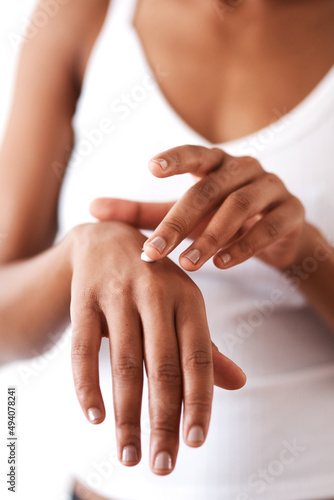 Keeping your hands moisturised is just as important. Studio shot of an unrecognizable woman moisturising her hands.