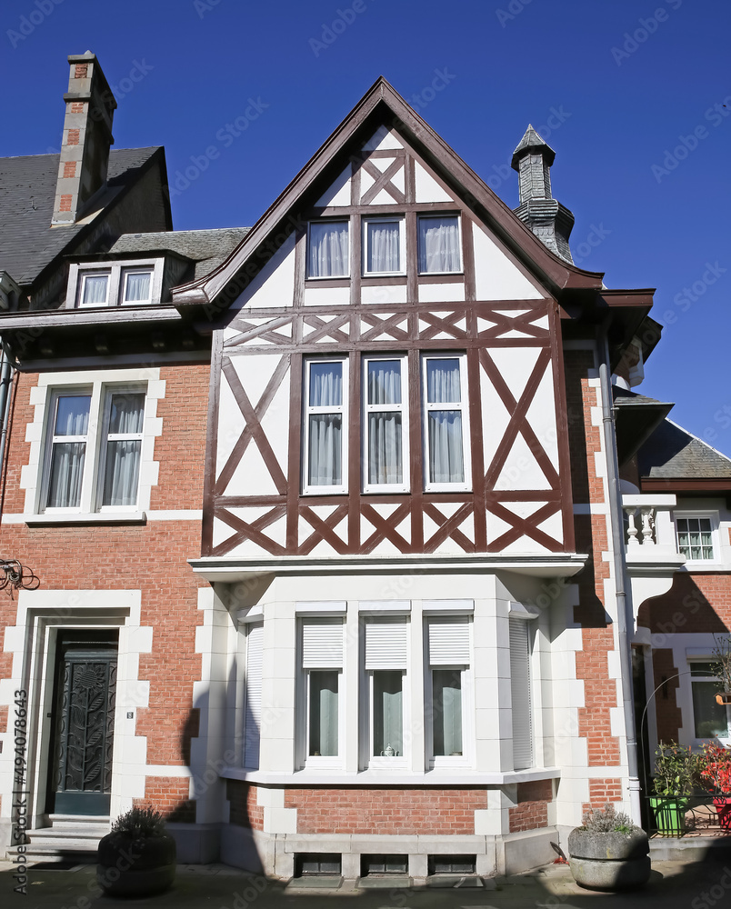 Dinant, Belgium - March 9. 2022: View on half timbered house facade against clear blue sky