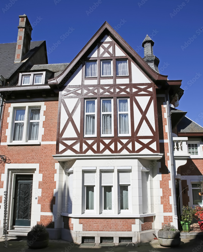 Obraz premium Dinant, Belgium - March 9. 2022: View on half timbered house facade against clear blue sky
