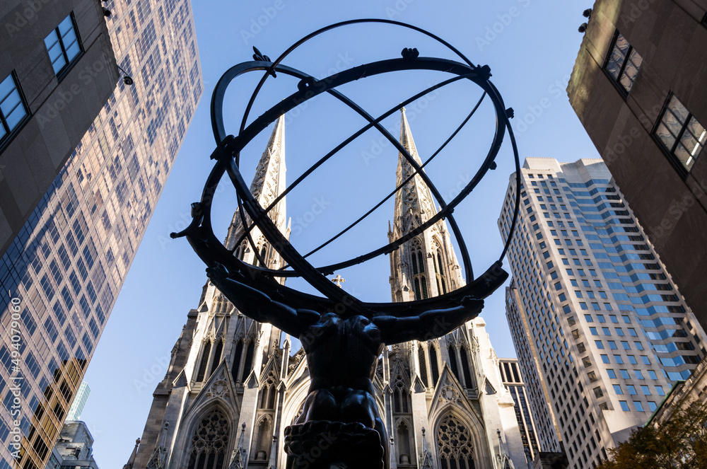 Statue at the Rockefeller Center with St Patrick Cathedral