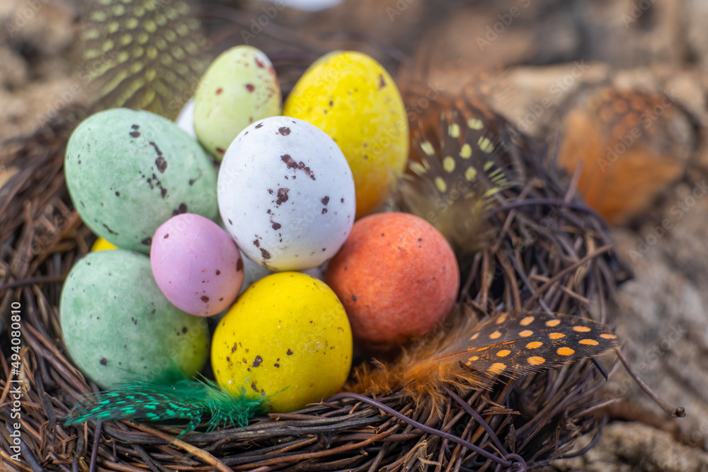 Easter candy eggs in different colors in nest Easter holiday candy concept. Easter candy eggs in different colors in nest Easter holiday candy concept.