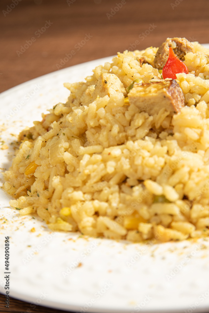 Vegan food, vegan risotto on a white plate, over wood, selective focus.