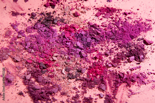 crushed powder eyeshadow makeup set isolated on pink background.