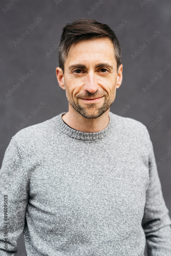 Portrait of a man in casual clothes, against a grey background Portrait of a man in casual clothes, against a grey background