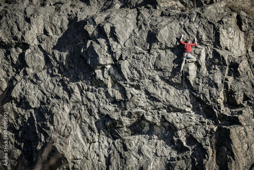 A climber tries to reach to top of a low mountain in central Stockholm, Sweden.
