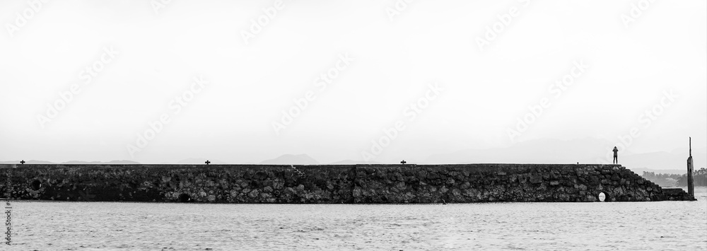black and white, a person in a malecon black and white, a person in a malecon