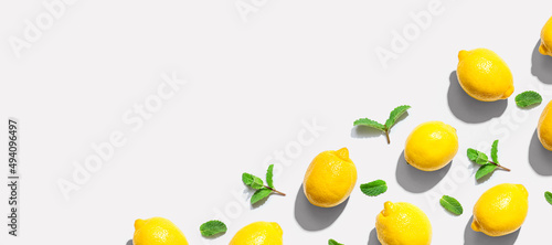 Fototapeta Naklejka Na Ścianę i Meble -  Fresh yellow lemons with mints overhead view - flat lay