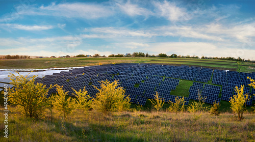 solar panels field station under blue sky on summer landscape