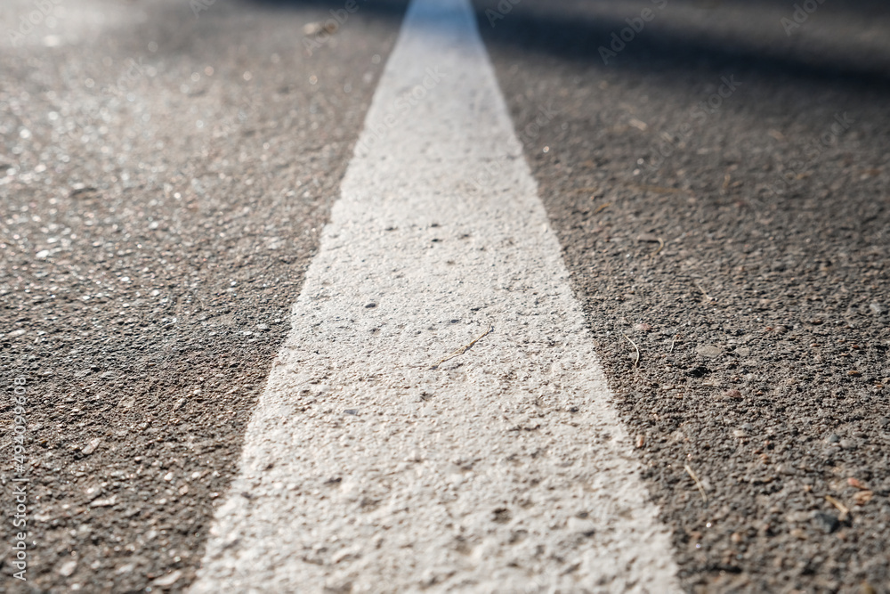 Obraz premium White solid line, road mark on asphalt road, right direction and success concept