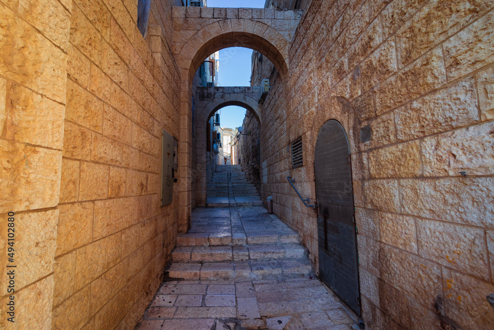 An old and ancient alley paved with stone tiles, in the Jewish Quarter - in the Old City of Jerusalem - Israel
