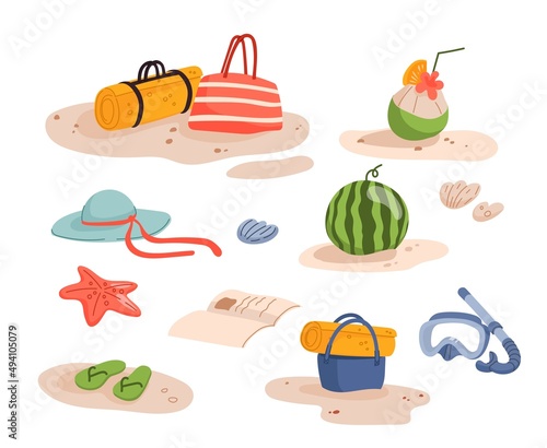 Summer beach vacation. Beach mat, watermelon, slates and book, coconut cocktail and underwater diving mask. Flat objects and isolated accessories for resort leisure and beach activities lying on sand