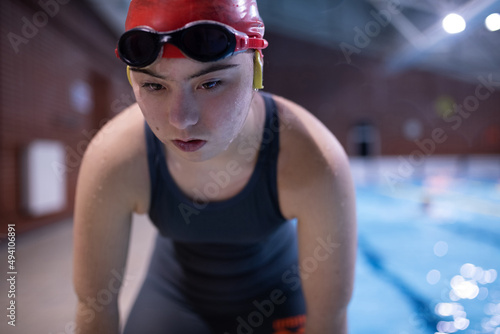 Young female swimmer with Down syndrome in swimming pool