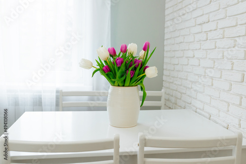 Bouquet of purple and white tulips on the kitchen table