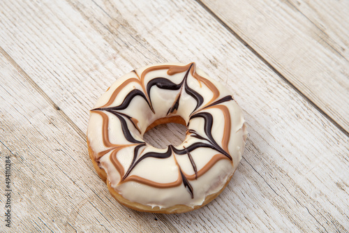 DonutDelicious donut with caramel glazed, Isolated on white and wood background. High quality photo