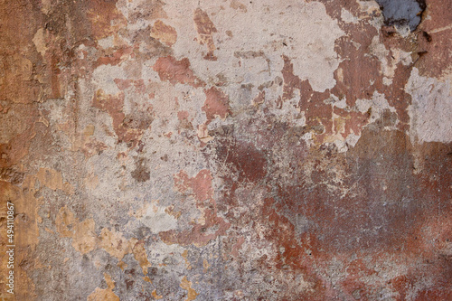 grimy and irregular textured surface of an abandoned and weathered wall - brown and gray colors