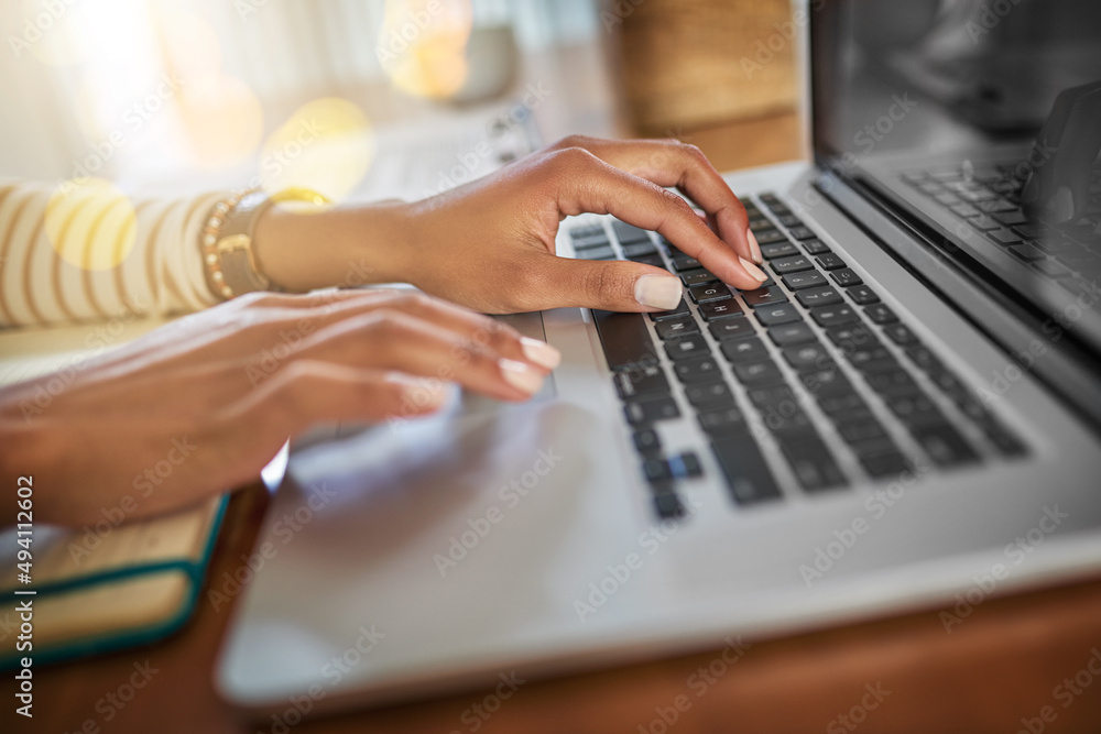 Time to get down to work. Closeup shot of an unrecognizable woman working on a laptop at home. Time to get down to work. Closeup shot of an unrecognizable woman working on a laptop at home.