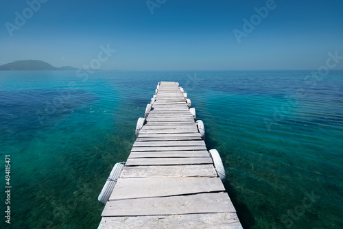 White old wooden pier on the seashore on a beautiful sunny day. Corfu Greece