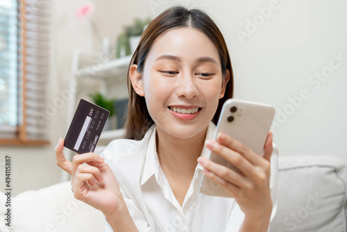 Online internet banking, asian young woman hand in payment spending by scan qr code, use phone, mobile to transfer money or pay money of credit card without cash at home. Technology of financial.