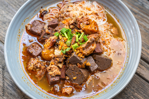 Rice Vermicelli noodles with pork spicy soup or Thai name is Khanom Jeen Nam Ngeow the favorite delicious famous food of Chiang Mai, Northern of Thailand. photo