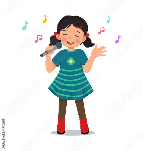 happy little girl singing a song with a microphone