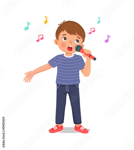 happy little boy singing a song with a microphone