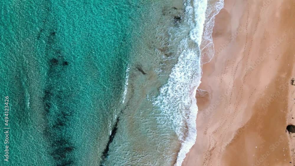 Aerial 4k top view of sea waves reaching sandy beach with crystal clear water and sandy coastline which offer you tropical exotic beach feeling with its natural untouched beauty in North Cyprus Aerial 4k top view of sea waves reaching sandy beach with crystal clear water and sandy coastline which offer you tropical exotic beach feeling with its natural untouched beauty in North Cyprus