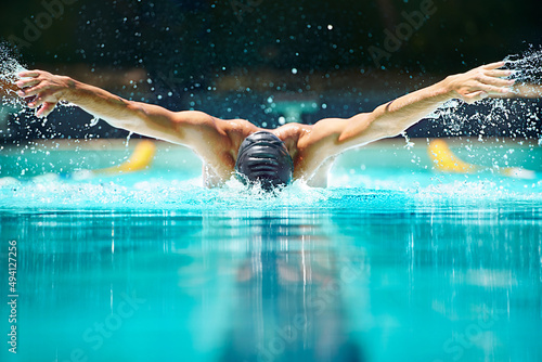 Perfect butterfly stroke. Shot of a male swimmer doing the butterfly stroke toward the camera. photo