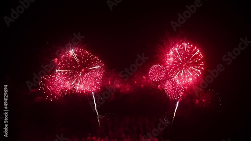 Big real fireworks display celebration and colorful New year's eve. An abstract blur of real golden shining with bokeh lights in the night sky.