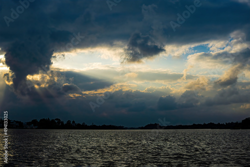 Beautiful scene of clouds and rays of sunlight with the ocean