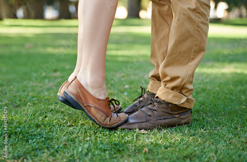 Closeup on young love. Cropped shot of a young girl standing tiptoe on her boyfriends feet.