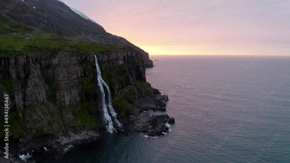 Waterfall Cascading On Rugged Cliff In Iceland - aerial drone shot Waterfall Cascading On Rugged Cliff In Iceland - aerial drone shot