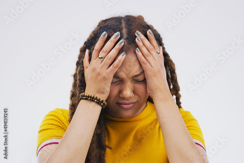 No, no, no. Studio shot of an attractive young woman looking stressed out against a grey background.
