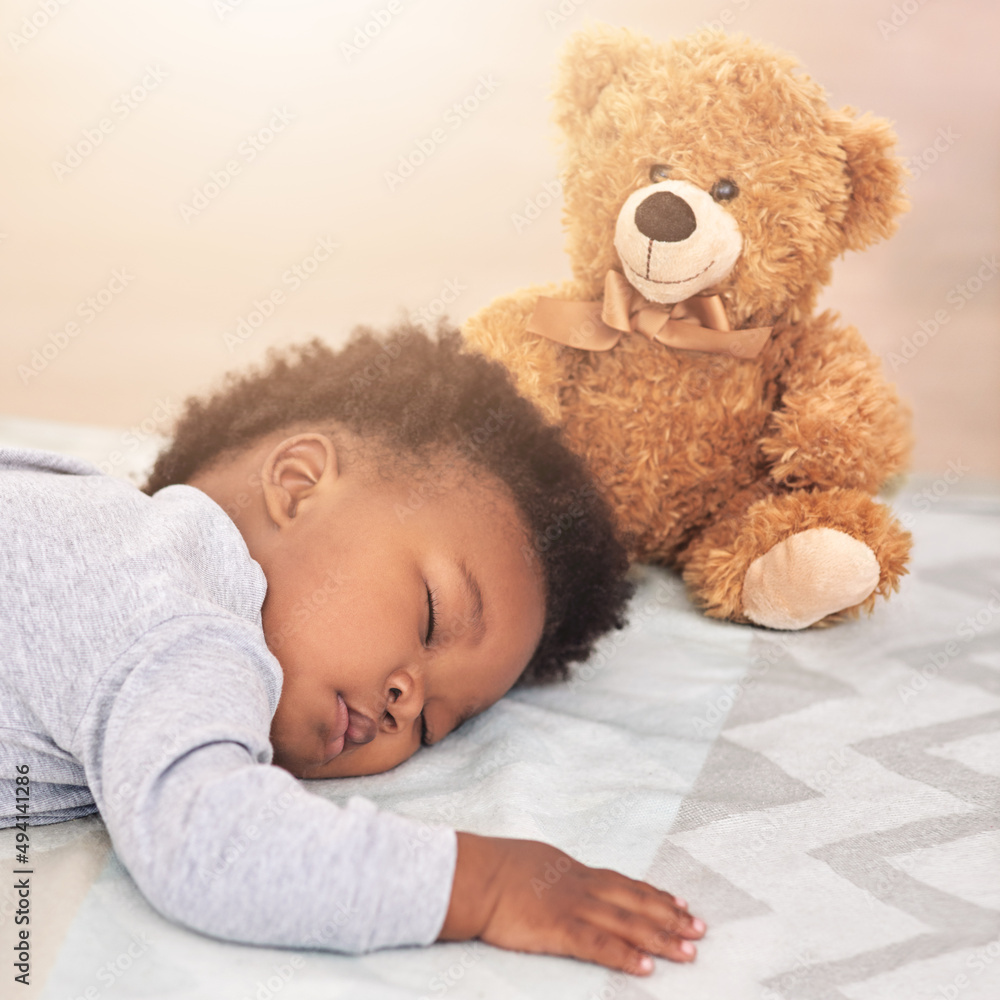 Dream big little one. Shot of a little baby boy sleeping on a bed with a teddy bear. Dream big little one. Shot of a little baby boy sleeping on a bed with a teddy bear.