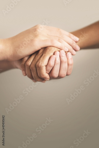 Give a helping hand. Cropped shot of two people holding hands in comfort.