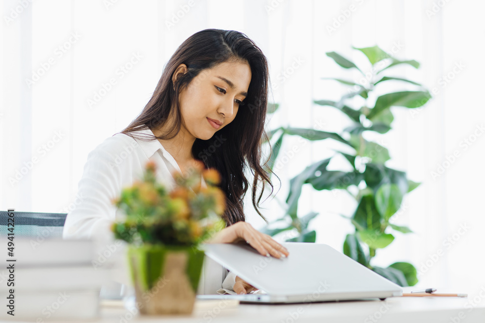 Asian young beautiful female university student sitting at working desk remotely studying learning streaming online via laptop notebook computer at home during quarantine Asian young beautiful female university student sitting at working desk remotely studying learning streaming online via laptop notebook computer at home during quarantine