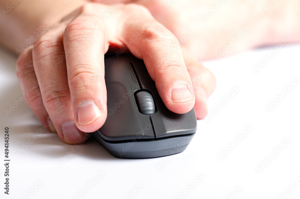 A computer mouse in a man's hand. White background. A computer mouse in a man's hand. White background.