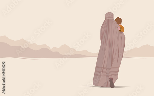 An Afghan woman in a burqa or burka with a child walks through the desert in search of freedom. Flight from the war. Refugee poster concept. Save the women of the east from violence and terrorism photo