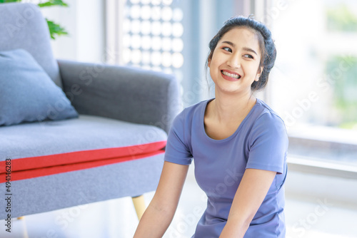 Asian young beautiful happy healthy female sport girl in casual sporty outfit sitting smiling holding hand up stretching arm and body exercising training routine yoga pilates practice in living room Free Download Asian young beautiful happy healthy female sport girl in casual sporty outfit sitting smiling holding hand up stretching arm and body exercising training routine yoga pilates practice in living room - GFXLoad