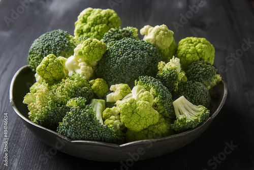 Ripe green cauliflower and broccoli. Dark wood background.