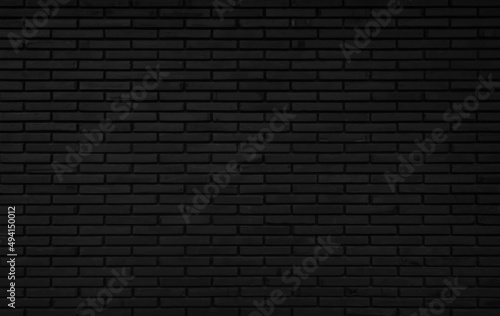 Black brick wall abstract background. Design geometric dark texture room decoration.