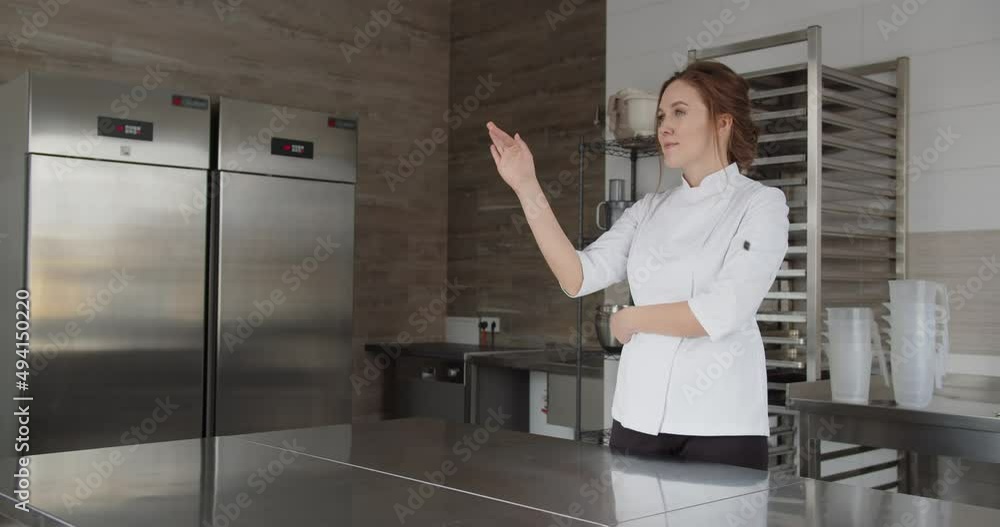 Cook-pastry chef presses on touch screen to choose necessary products for cooking Cook-pastry chef presses on touch screen to choose necessary products for cooking