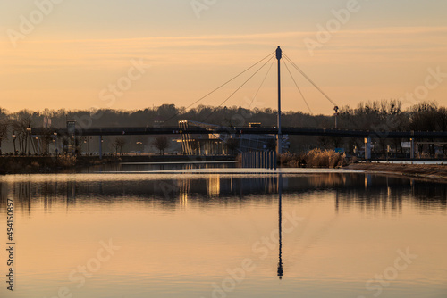 Fototapeta Naklejka Na Ścianę i Meble -  Sunset over  the hanging bridge in Giżycko