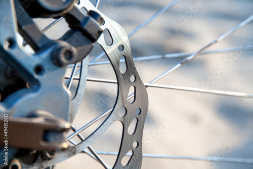 Used mountain bike disc brake close-up. Blurry background