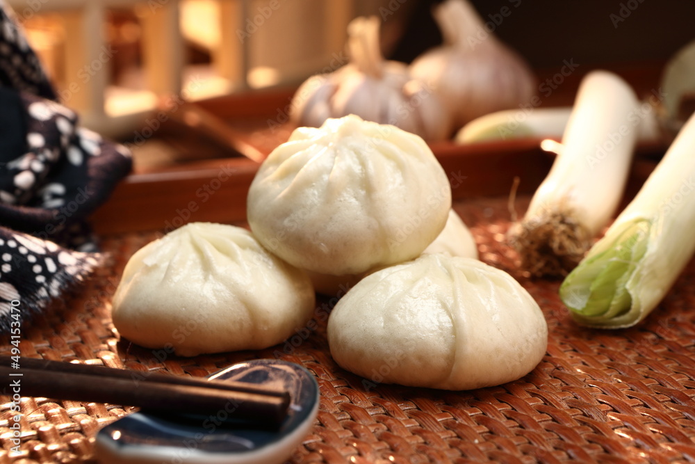 Delicious baozi, Chinese steamed meat bun is ready to eat on serving plate and steamer, close up, copy space product design concept. Delicious baozi, Chinese steamed meat bun is ready to eat on serving plate and steamer, close up, copy space product design concept.